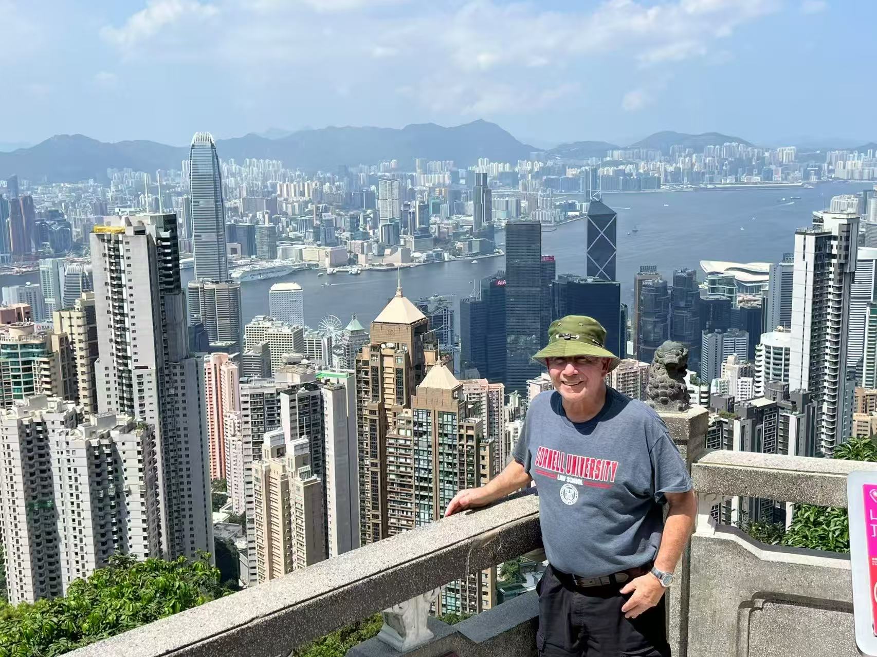Traveler overlooking Hong Kong harbor and skyline