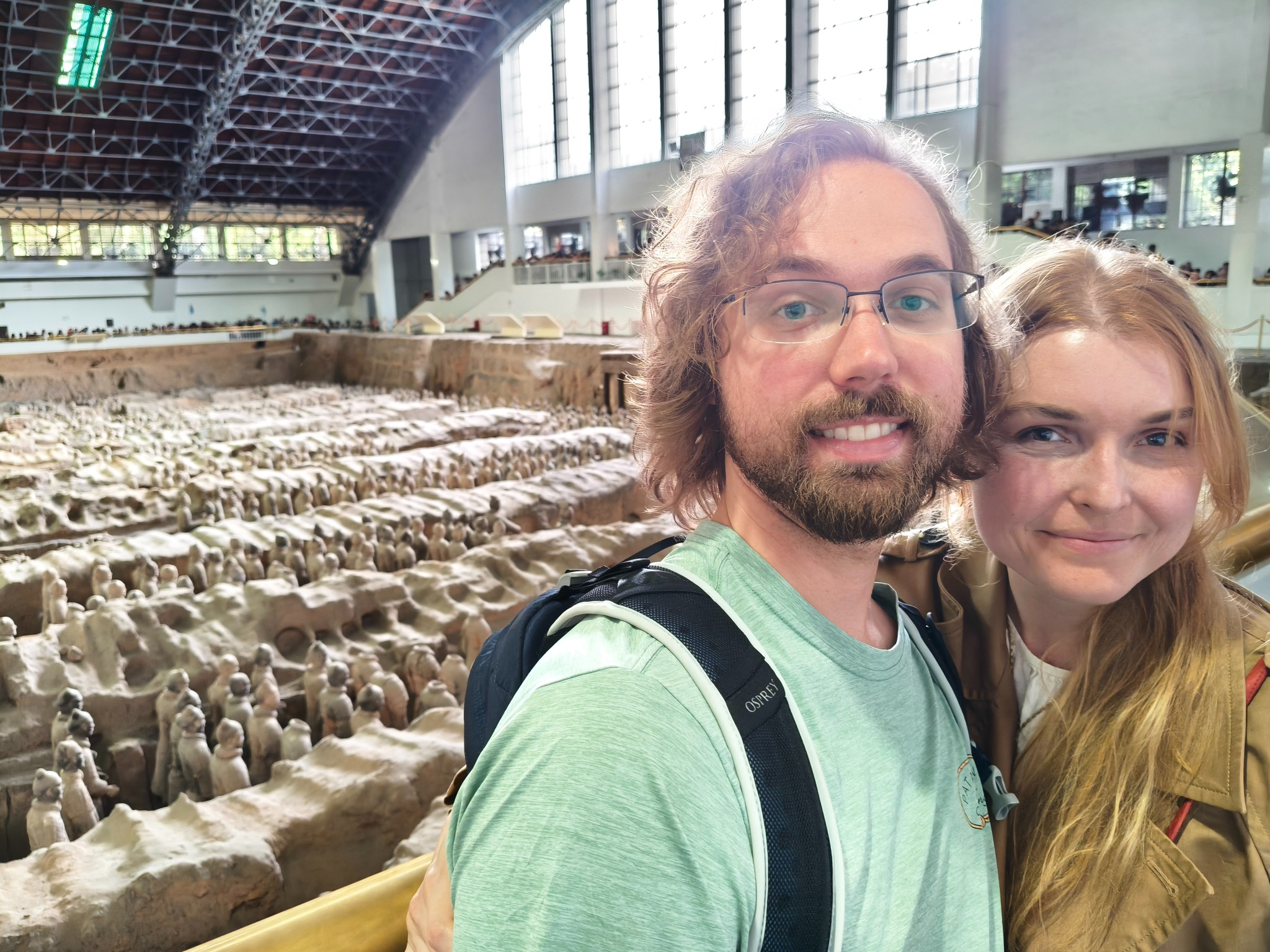 Two travelers taking a photo above the Terracotta Army excavation